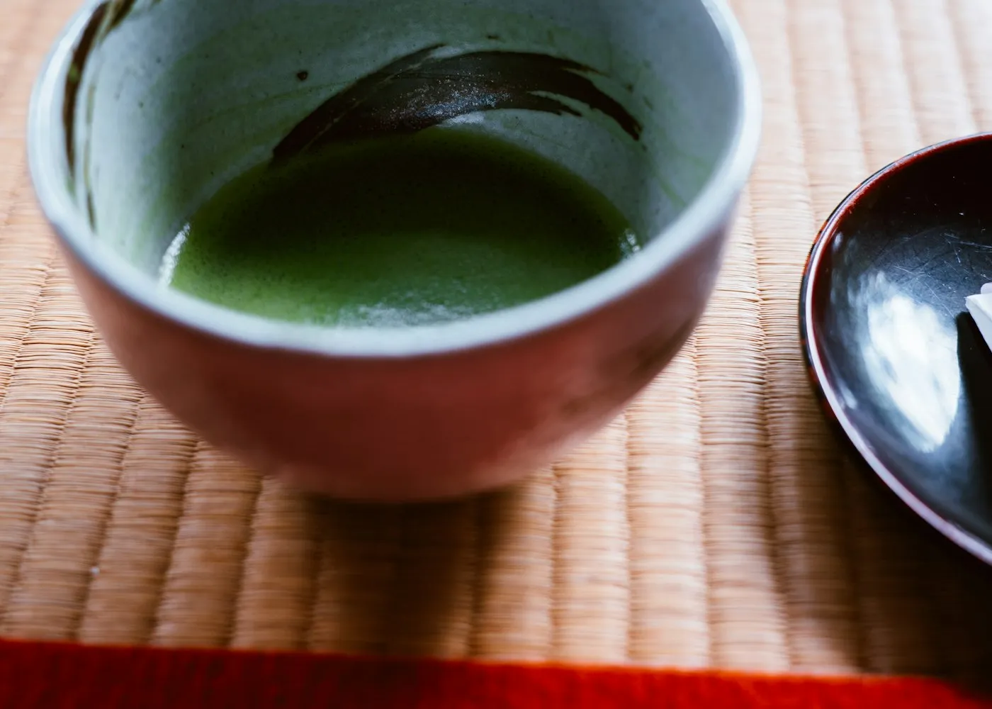 A bowl of matcha tea on a tatami mat