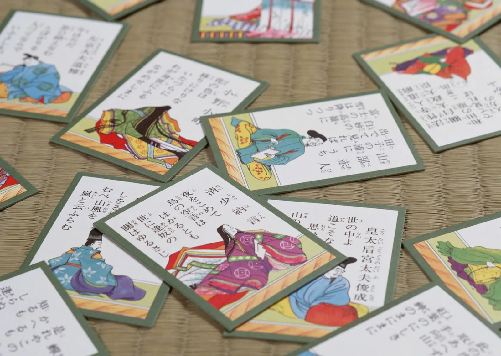 Colorful Hyakunin Isshu karuta poem cards scattered on a tatami mat