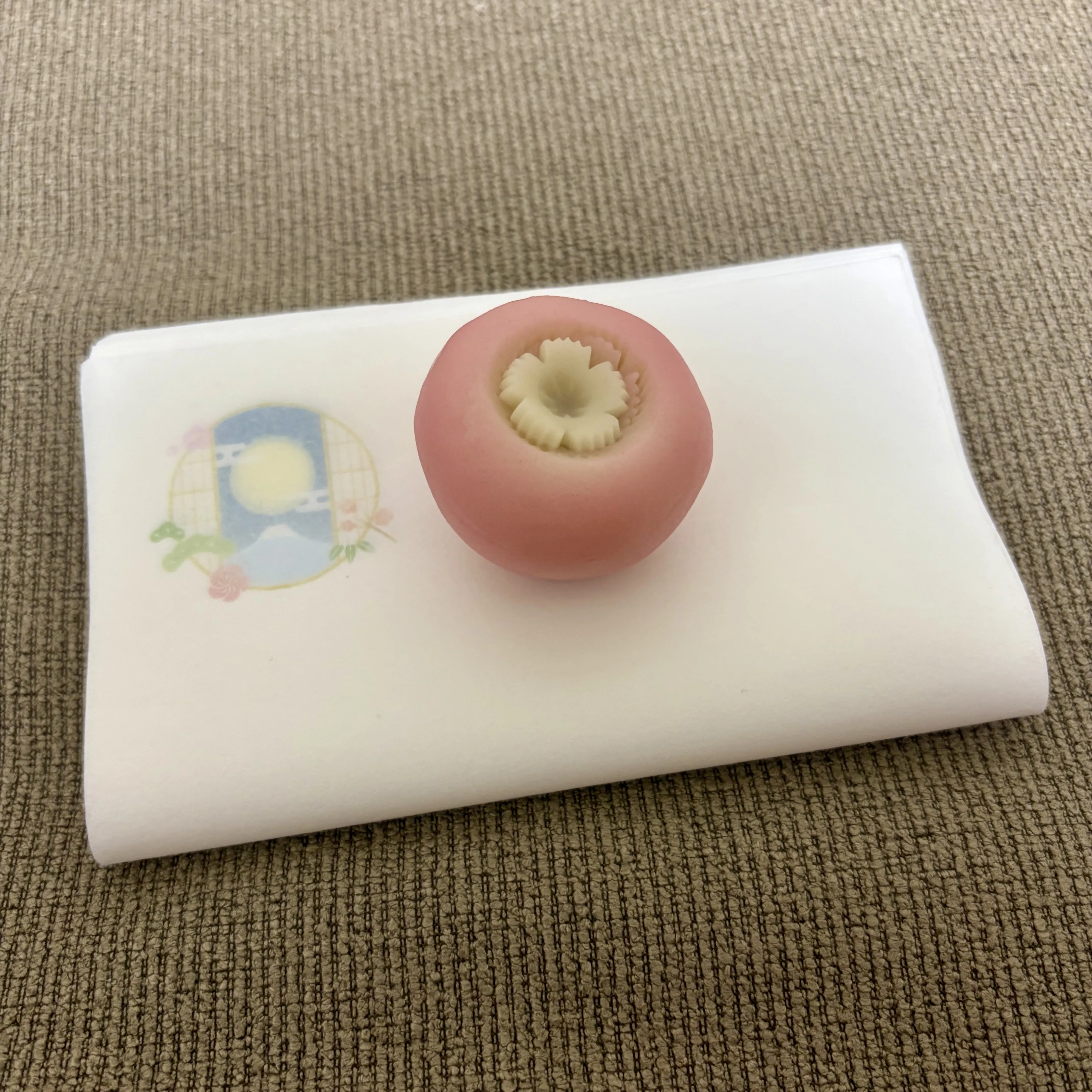 A persimmon-shaped namagashi wagashi sweet, an autumn motif, on a black lacquer tray